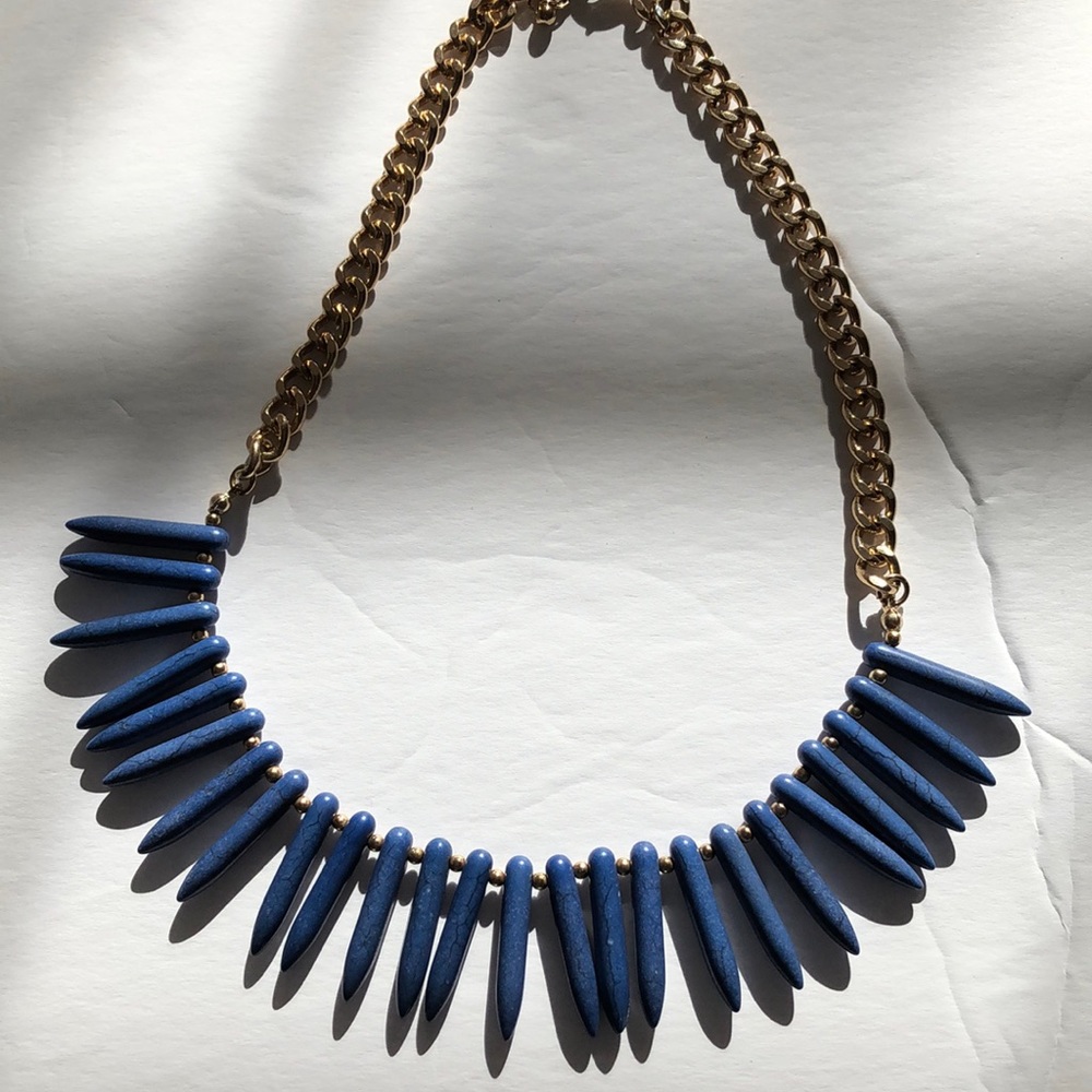 “Wood” beaded necklace. Color is a light navy blue , gold chain accent
